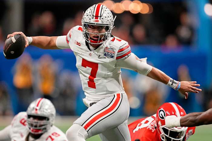 Dec 31, 2022; Atlanta, Georgia, USA; Ohio State Buckeyes quarterback C.J. Stroud (7) evades pressure from the Georgia Bulldogs during the second quarter of the 2022 Peach Bowl at Mercedes-Benz Stadium. Mandatory Credit: Dale Zanine-USA TODAY Sports